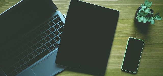 Laptop, tablet, and cellphone on table